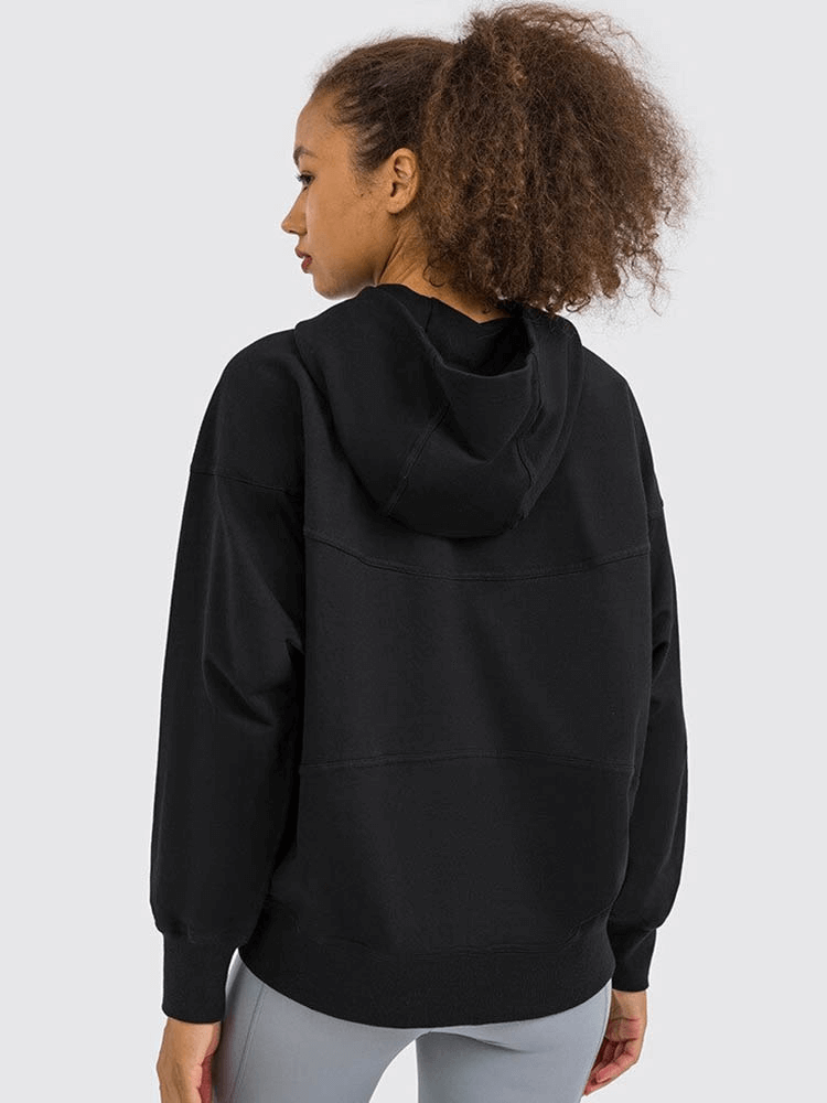 Woman wearing women's batwing sleeves hoodie in black, perfect for running or outdoor activities, showcasing back view.